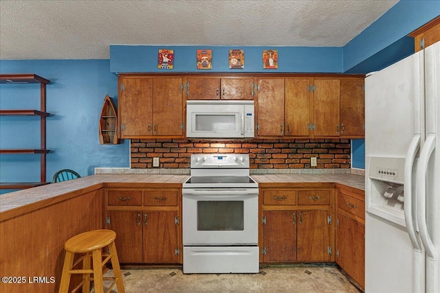 3003 Cherry Blvd, Beaufort, SC 29902 - kitchen featuring white appliances, brown cabinetry, tile countertops, a textured ceiling, and concrete flooring