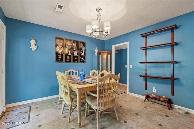 3003 Cherry Blvd, Beaufort, SC 29902 - dining area featuring a chandelier, baseboards, and a textured ceiling