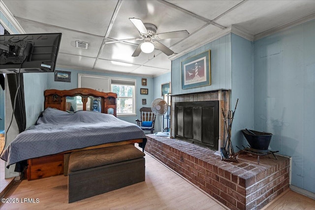 3003 Cherry Blvd, Beaufort, SC 29902 - bedroom with wood finished floors, a fireplace, and ceiling fan