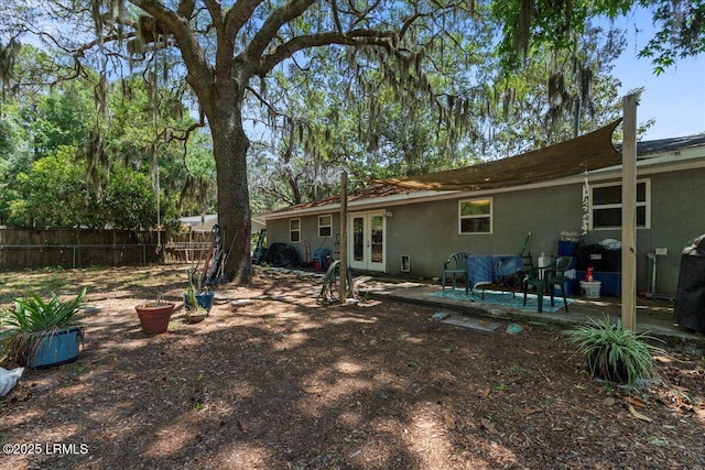 3003 Cherry Blvd, Beaufort, SC 29902 - rear view of house with french doors, stucco siding, fence, and a patio