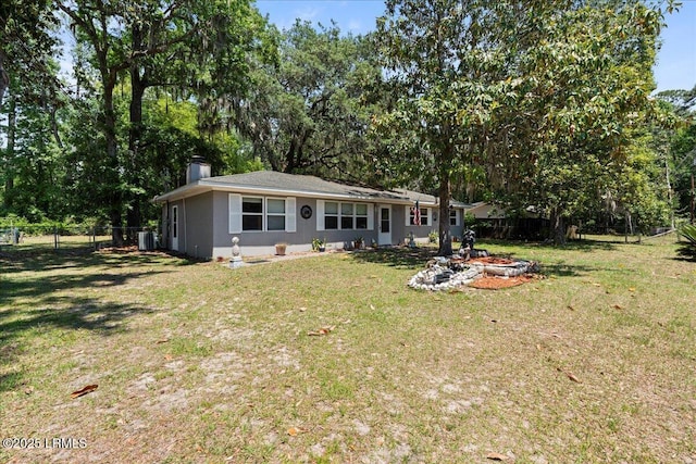 3003 Cherry Blvd, Beaufort, SC 29902 - rear view of property with a fire pit, a chimney, and view of scattered trees