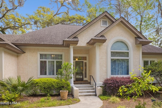 8 Chechessee Cir, Okatie, SC 29909 - view of exterior entry with stucco siding and a shingled roof