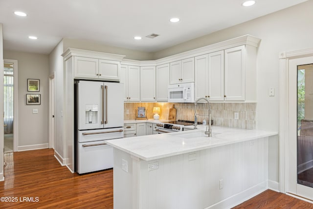8 Chechessee Cir, Okatie, SC 29909 - kitchen featuring white appliances, visible vents, dark wood-style flooring, and baseboards
