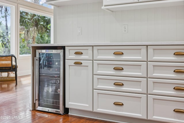 8 Chechessee Cir, Okatie, SC 29909 - bar featuring wood-type flooring, wooden walls, and wine cooler