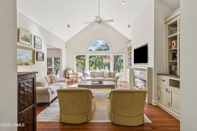 8 Chechessee Cir, Okatie, SC 29909 - living area featuring high vaulted ceiling, wood finished floors, a glass covered fireplace, and a ceiling fan