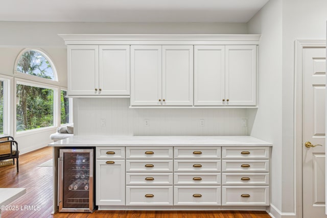 8 Chechessee Cir, Okatie, SC 29909 - bar with wine cooler, baseboards, and wood finished floors