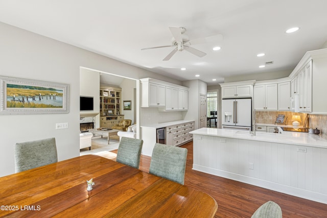 8 Chechessee Cir, Okatie, SC 29909 - kitchen featuring light countertops, a ceiling fan, white appliances, a peninsula, and dark wood-style floors