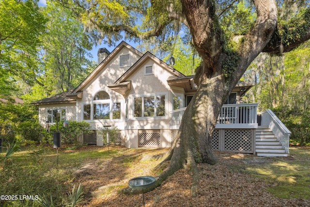8 Chechessee Cir, Okatie, SC 29909 - back of house featuring a sunroom, a chimney, stairway, stucco siding, and a wooden deck