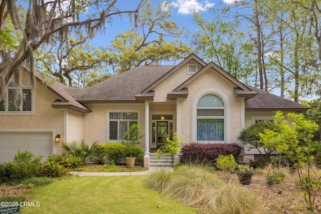 8 Chechessee Cir, Okatie, SC 29909 - view of front of home with a front lawn, a shingled roof, a garage, and stucco siding