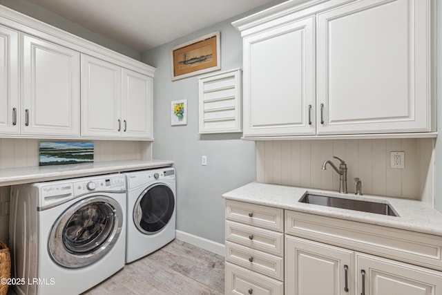 8 Chechessee Cir, Okatie, SC 29909 - laundry area with baseboards, a sink, light wood-style floors, independent washer and dryer, and cabinet space
