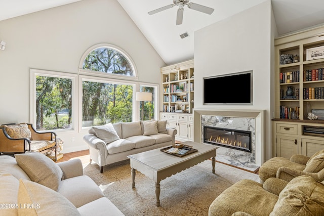 8 Chechessee Cir, Okatie, SC 29909 - living room featuring built in features, a ceiling fan, visible vents, high vaulted ceiling, and a high end fireplace