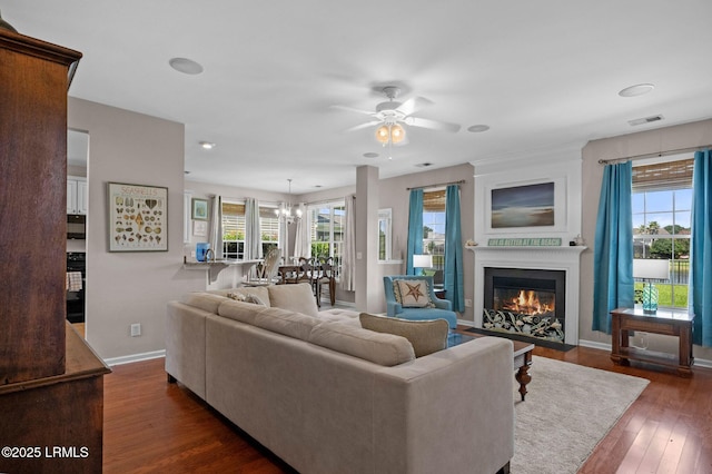 176 Pickett Mill Blvd, Bluffton, SC 29909 - living area featuring ceiling fan, dark wood-style floors, a fireplace with flush hearth, and a chandelier