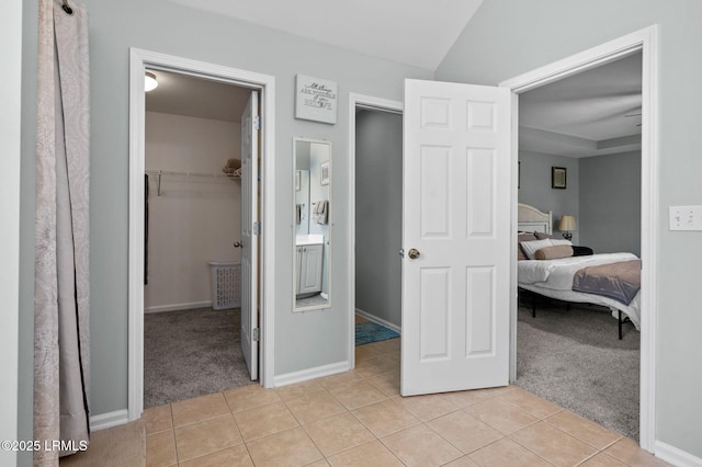 176 Pickett Mill Blvd, Bluffton, SC 29909 - bedroom with light colored carpet, a walk in closet, light tile patterned floors, and a closet