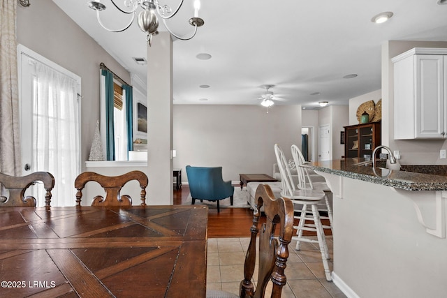 176 Pickett Mill Blvd, Bluffton, SC 29909 - dining space with a ceiling fan, light tile patterned floors, and a chandelier