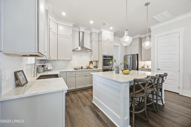 6 Skipperling Ct, Bluffton, SC 29909 - kitchen with wall chimney range hood, appliances with stainless steel finishes, a center island, dark wood-style floors, and backsplash