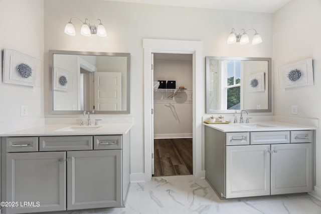 6 Skipperling Ct, Bluffton, SC 29909 - bathroom with marble look tile flooring, two vanities, and a spacious closet