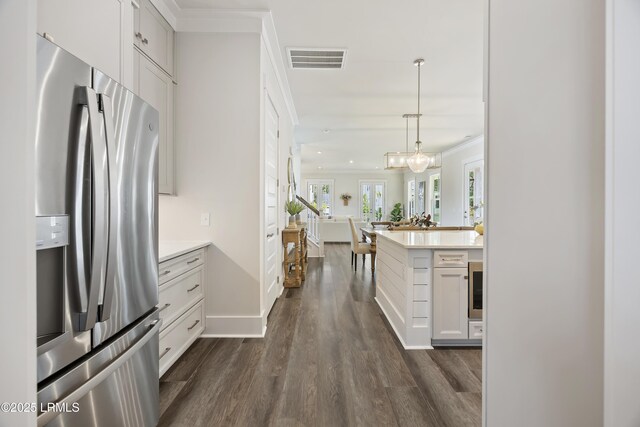 6 Skipperling Ct, Bluffton, SC 29909 - kitchen featuring stainless steel fridge with ice dispenser, light countertops, dark wood-type flooring, open floor plan, and white cabinets