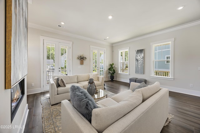 6 Skipperling Ct, Bluffton, SC 29909 - living area featuring crown molding, baseboards, recessed lighting, dark wood-style floors, and a glass covered fireplace