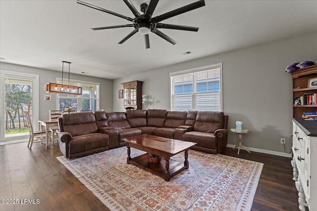 living room with ceiling fan and dark hardwood / wood-style flooring