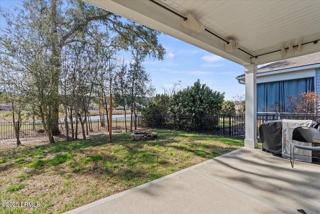 view of yard with an outdoor fire pit and a patio