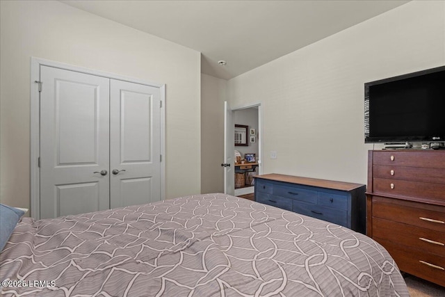 bedroom with lofted ceiling and a closet