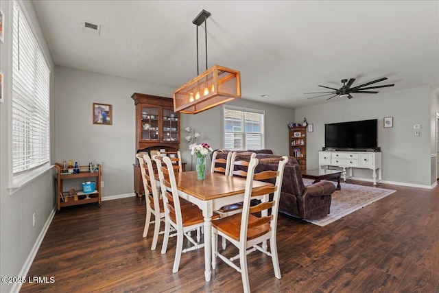 dining area with dark hardwood / wood-style floors and ceiling fan