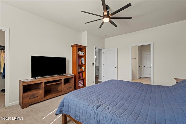 carpeted bedroom with ceiling fan and ensuite bath