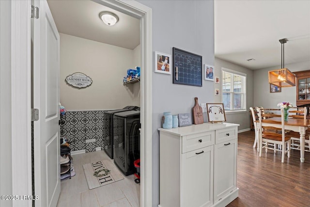 kitchen with pendant lighting, white cabinets, and light wood-type flooring