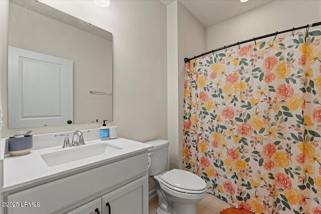 bathroom featuring vanity, tile patterned flooring, a shower with curtain, and toilet