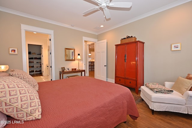 bedroom with crown molding, recessed lighting, ceiling fan, wood finished floors, and baseboards