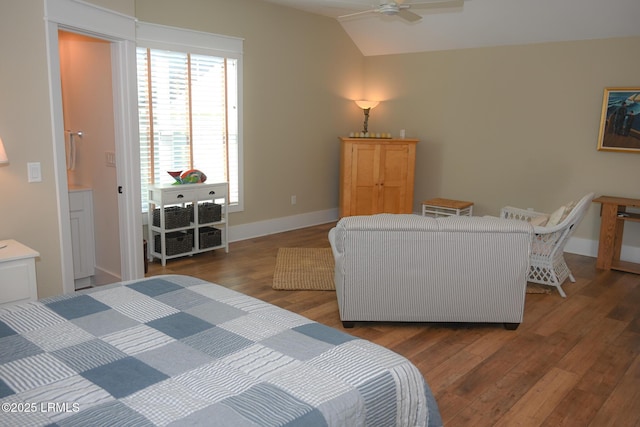 bedroom featuring vaulted ceiling, wood finished floors, and baseboards