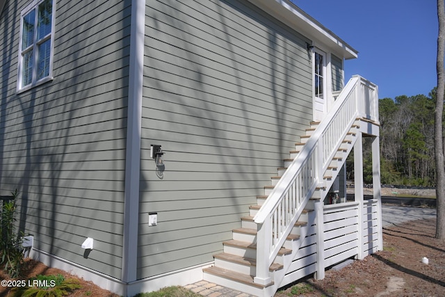 view of side of home featuring stairway