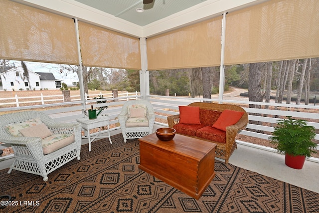 sunroom / solarium featuring a ceiling fan