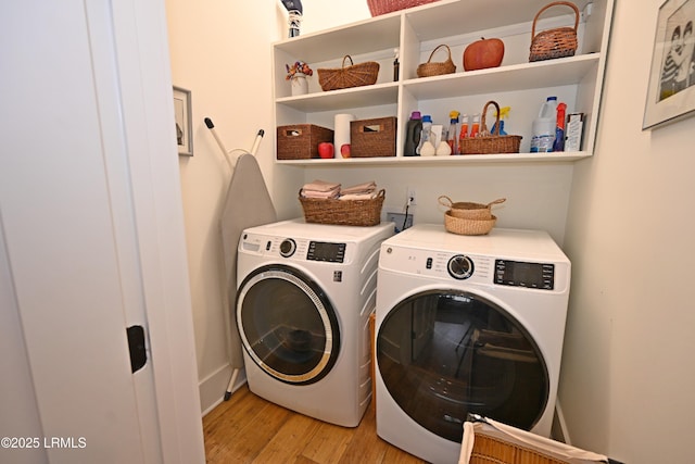 clothes washing area with light wood-type flooring, laundry area, and independent washer and dryer