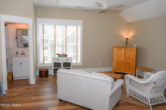 living area featuring baseboards, visible vents, lofted ceiling, ceiling fan, and wood finished floors