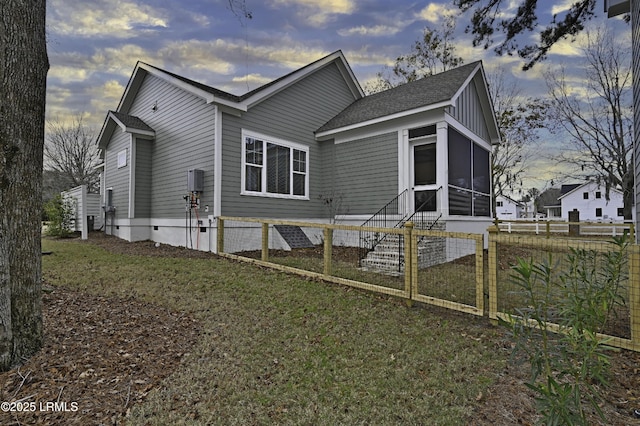 exterior space featuring a yard, a sunroom, and fence