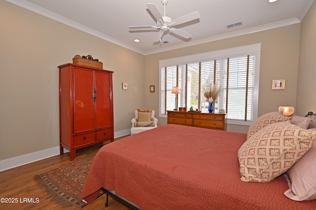 bedroom featuring recessed lighting, wood finished floors, visible vents, baseboards, and crown molding