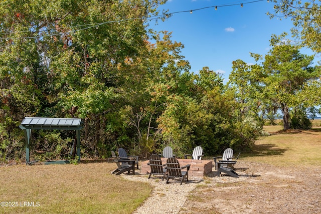 view of yard featuring an outdoor fire pit