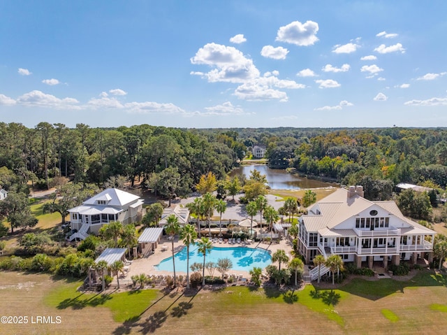 drone / aerial view with a water view and a wooded view