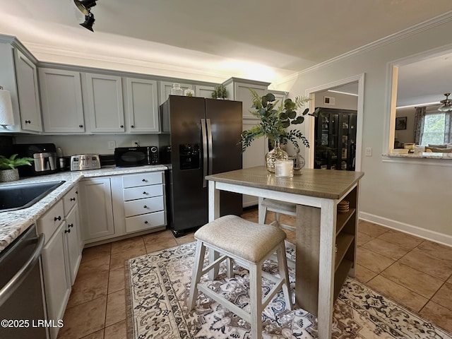 2410 Pine Ct N, Beaufort, SC 29902 - kitchen featuring appliances with stainless steel finishes, light tile patterned flooring, crown molding, a sink, and baseboards