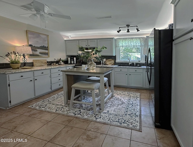 2410 Pine Ct N, Beaufort, SC 29902 - kitchen featuring a sink, ornamental molding, freestanding refrigerator, ceiling fan, and a kitchen island