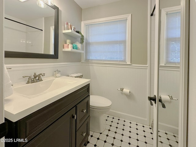 2410 Pine Ct N, Beaufort, SC 29902 - bathroom with vanity, a wainscoted wall, toilet, healthy amount of natural light, and tile patterned floors