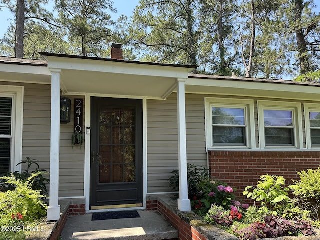 2410 Pine Ct N, Beaufort, SC 29902 - doorway to property with a chimney and brick siding