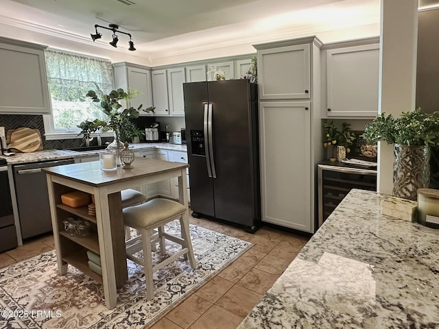 2410 Pine Ct N, Beaufort, SC 29902 - kitchen with appliances with stainless steel finishes, beverage cooler, light tile patterned flooring, and light stone countertops