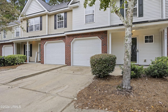 multi unit property featuring a garage