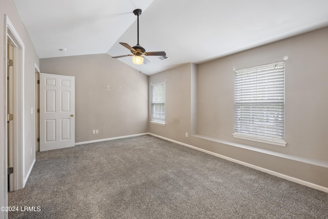 unfurnished bedroom with lofted ceiling, carpet, and ceiling fan