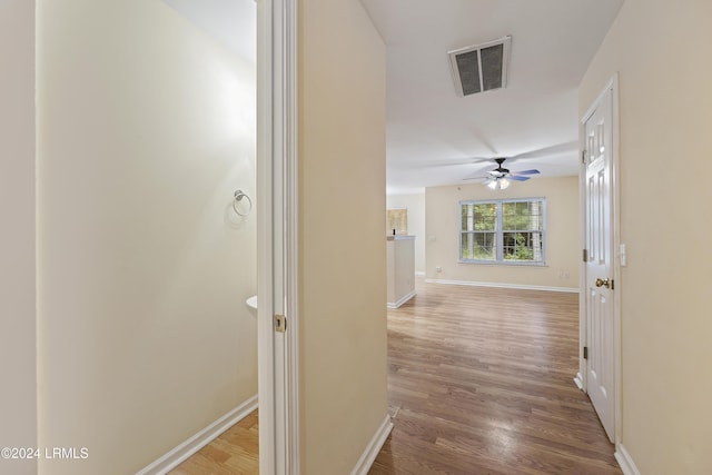 corridor with wood-type flooring