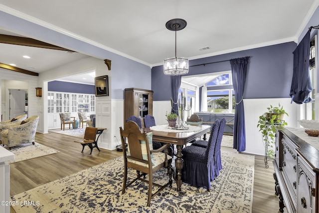 1619 Promenade Ln, Okatie, SC 29909 - dining space with a chandelier, light wood-style flooring, ornamental molding, and wainscoting