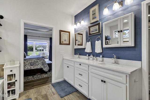 1619 Promenade Ln, Okatie, SC 29909 - bathroom featuring double vanity, ensuite bathroom, baseboards, and wood finished floors