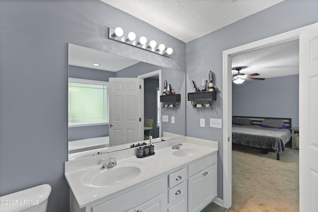 93 Heartstone Cir, Bluffton, SC 29910 - ensuite bathroom featuring a textured ceiling, double vanity, toilet, and a ceiling fan